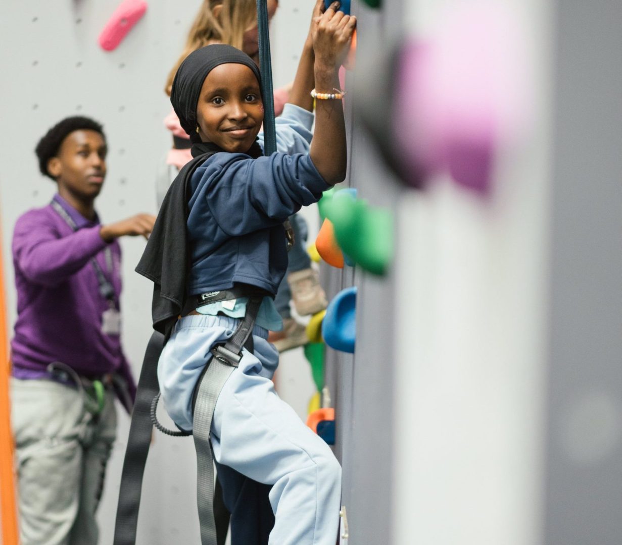 Young person on the climbing wall at WEST Youth Zone